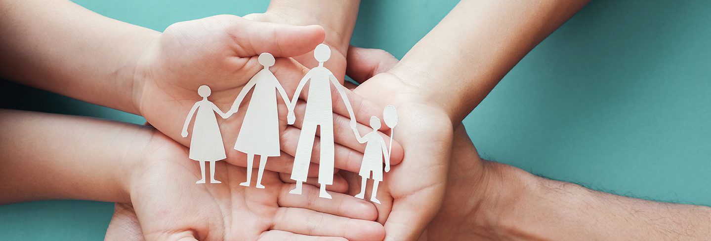 hands holding paper family cutout, family home, adoption, foster care, homeless charity ,social distancing, family mental health, homeschooling education, Autism support, domestic violence